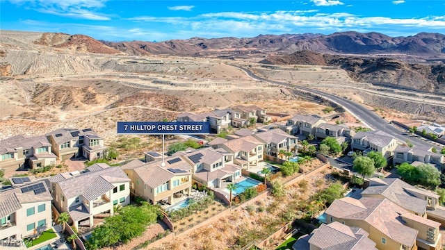 birds eye view of property with a mountain view