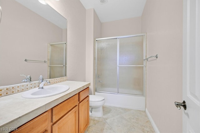 full bathroom featuring vanity, toilet, tile patterned floors, and shower / bath combination with glass door