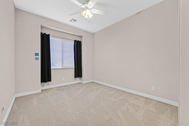 carpeted spare room featuring ceiling fan