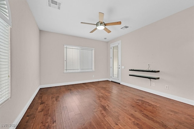 spare room featuring wood-type flooring and ceiling fan