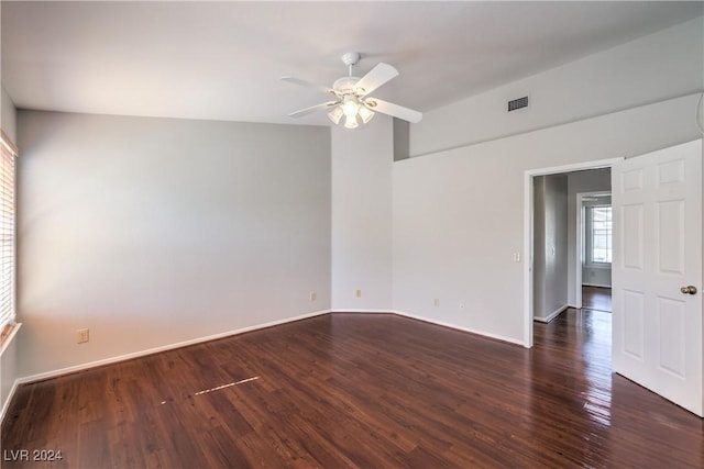 spare room featuring visible vents, ceiling fan, baseboards, and wood finished floors