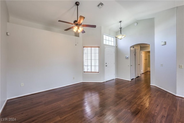 spare room with arched walkways, ceiling fan, wood finished floors, and visible vents