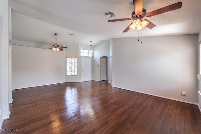 spare room with arched walkways, ceiling fan, lofted ceiling, visible vents, and dark wood-style floors