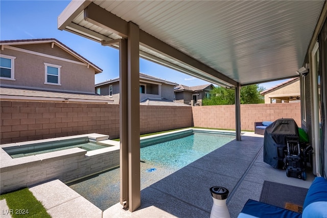 view of pool with grilling area, a patio, and an in ground hot tub