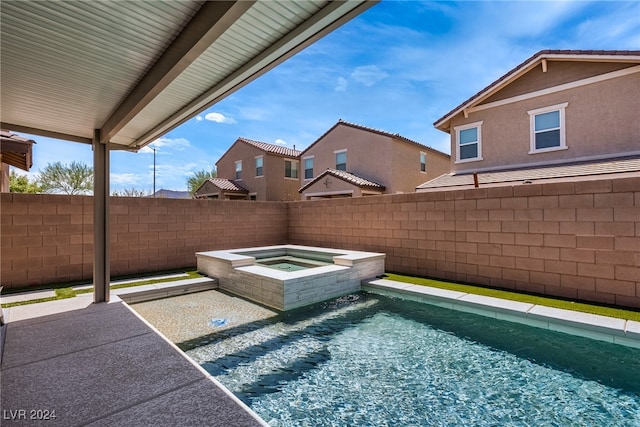 view of pool featuring an in ground hot tub