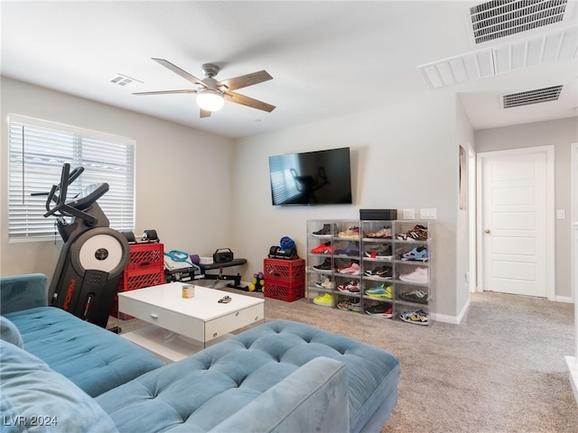 living room with light colored carpet and ceiling fan