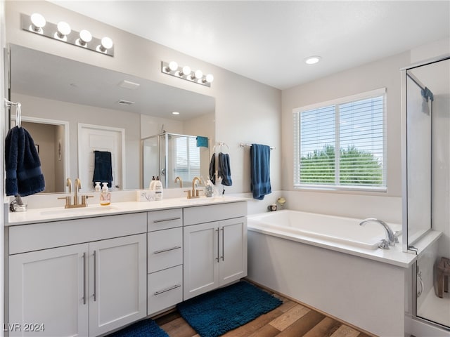 bathroom featuring hardwood / wood-style floors, vanity, and independent shower and bath