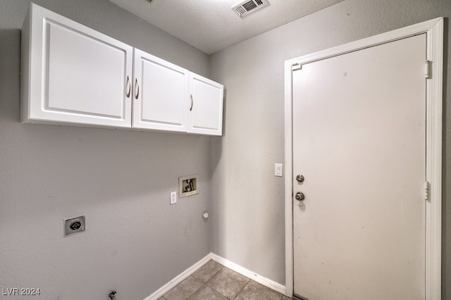 laundry area featuring electric dryer hookup, gas dryer hookup, light tile patterned flooring, and washer hookup