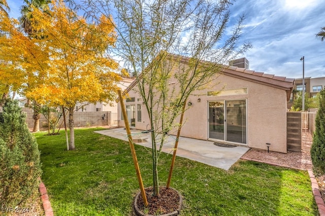 rear view of house with a patio area and a yard