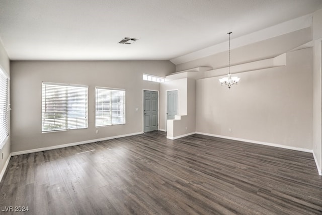 unfurnished room with dark hardwood / wood-style flooring, a healthy amount of sunlight, lofted ceiling, and a notable chandelier