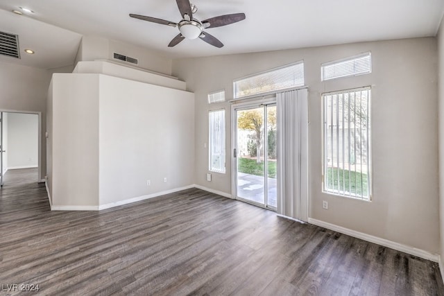 empty room with ceiling fan, dark wood-type flooring, and lofted ceiling