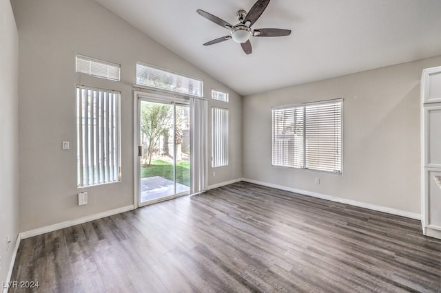 spare room with ceiling fan, dark hardwood / wood-style flooring, plenty of natural light, and vaulted ceiling