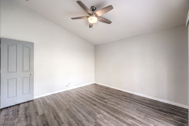 empty room with dark hardwood / wood-style flooring, vaulted ceiling, and ceiling fan