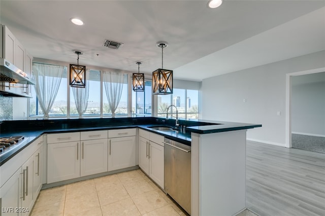 kitchen with appliances with stainless steel finishes, sink, and white cabinets