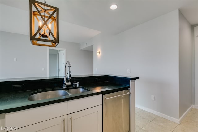 kitchen with hanging light fixtures, light tile patterned floors, white cabinetry, dishwasher, and sink