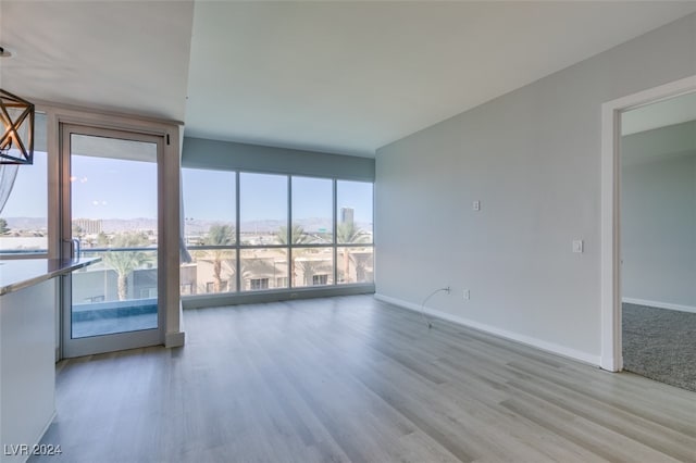 unfurnished room featuring light hardwood / wood-style floors