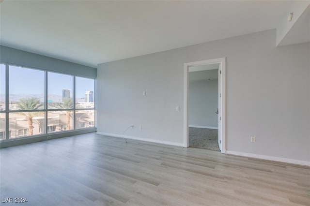 unfurnished room featuring light hardwood / wood-style floors