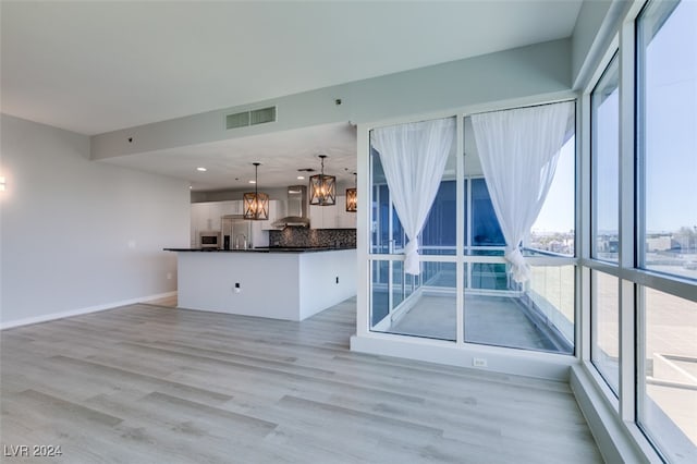 interior space featuring a notable chandelier and light wood-type flooring