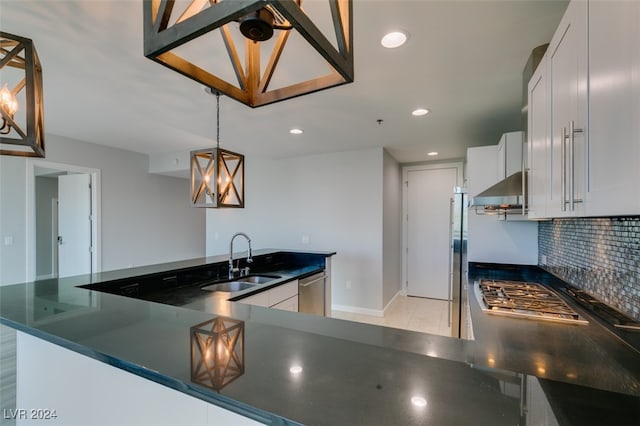 kitchen featuring white cabinetry, appliances with stainless steel finishes, sink, and decorative backsplash