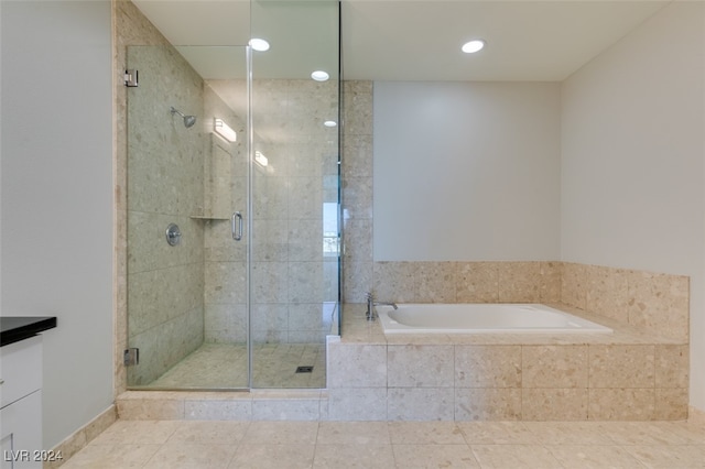 bathroom featuring vanity, independent shower and bath, and tile patterned floors