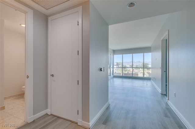 corridor featuring light hardwood / wood-style floors