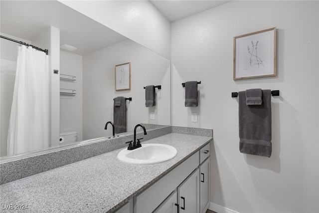 bathroom featuring toilet and vanity