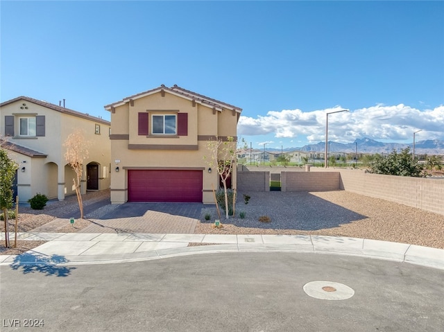 view of front of home with a mountain view and a garage