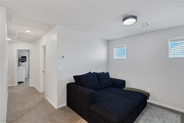 living area with a wealth of natural light and light colored carpet