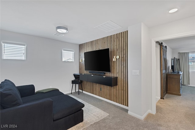 living room with carpet flooring and a barn door