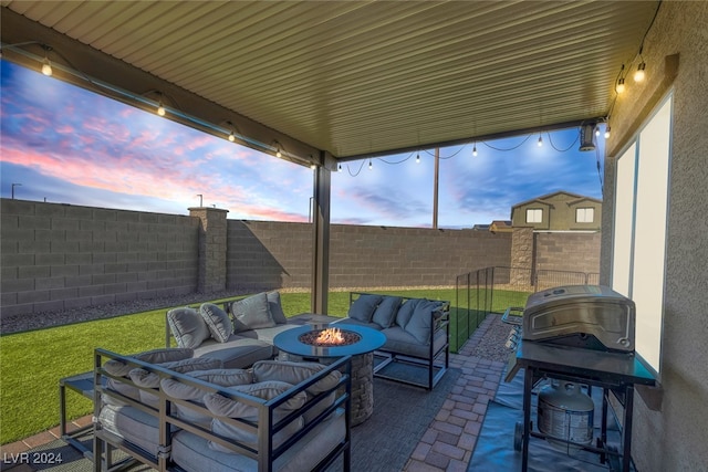 patio terrace at dusk featuring an outdoor living space with a fire pit