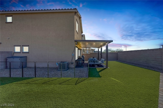 exterior space with outdoor lounge area, a yard, cooling unit, and a patio