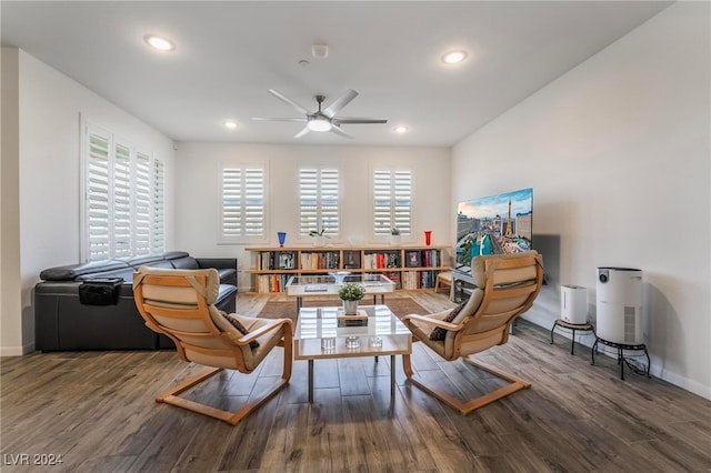 living area with hardwood / wood-style flooring and ceiling fan