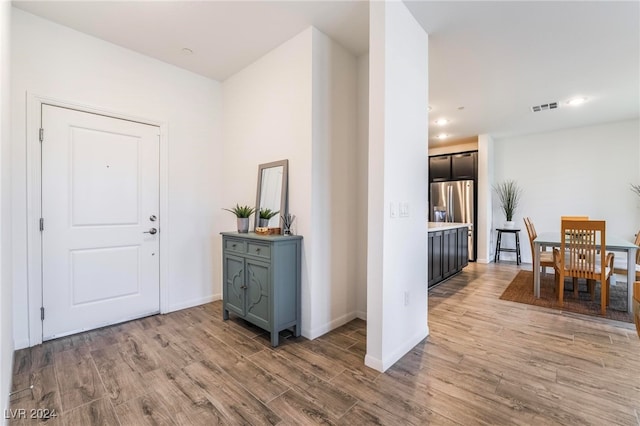 foyer entrance with light hardwood / wood-style floors