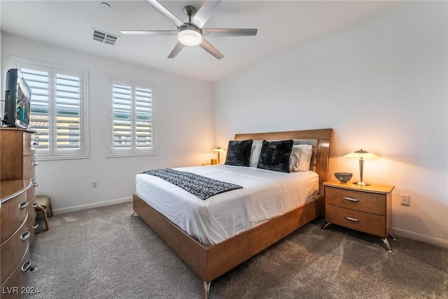 bedroom featuring ceiling fan and dark carpet