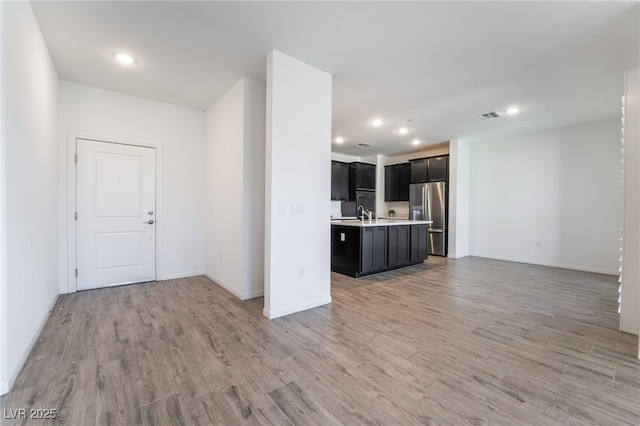 unfurnished living room with light hardwood / wood-style floors