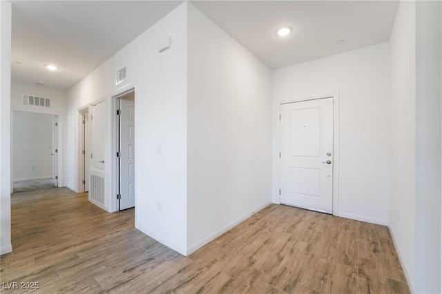 corridor with light hardwood / wood-style flooring