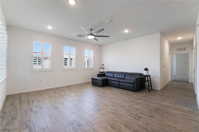 living room with ceiling fan and wood-type flooring