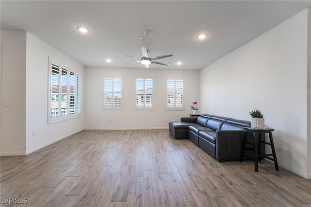 living room with ceiling fan and light hardwood / wood-style floors