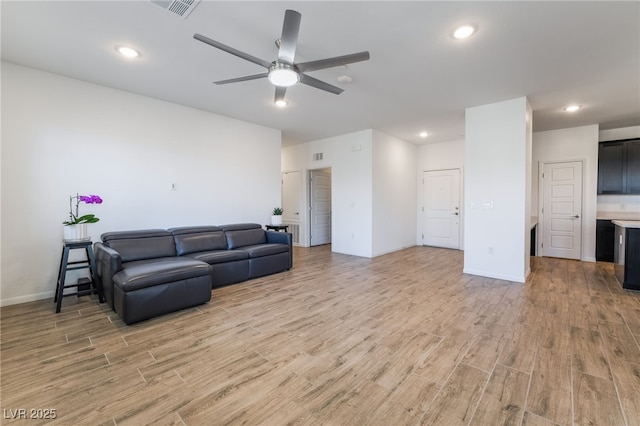 living room featuring ceiling fan and light wood-type flooring