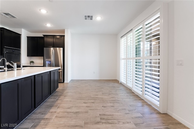 kitchen with stainless steel fridge with ice dispenser and sink