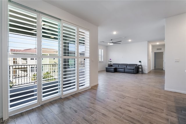 interior space featuring ceiling fan and a wealth of natural light