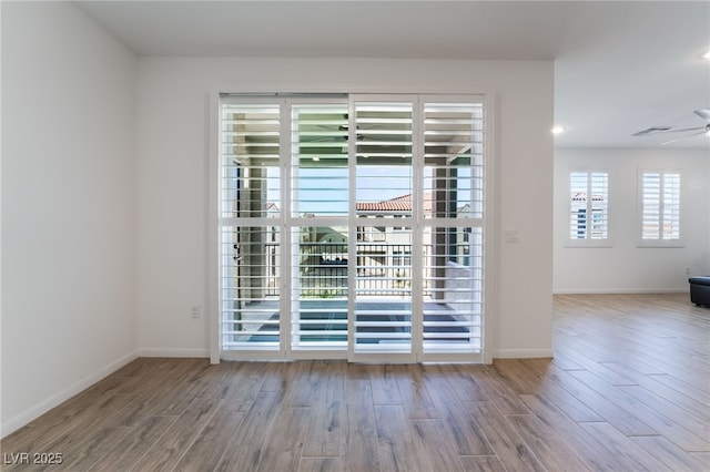 empty room with light wood-type flooring and ceiling fan