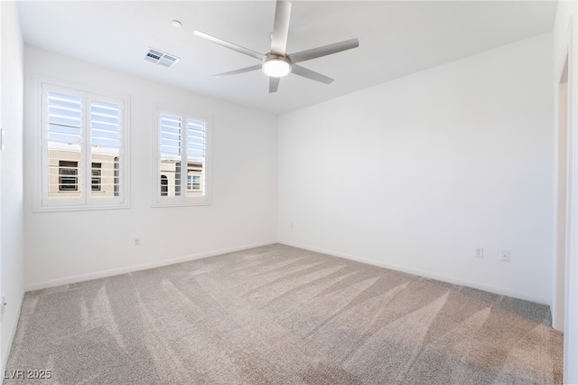 carpeted spare room with ceiling fan