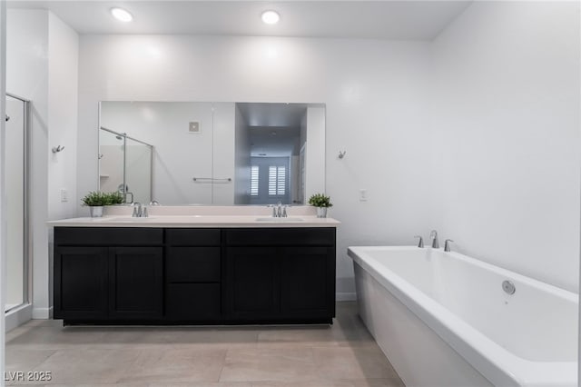 bathroom with separate shower and tub and vanity