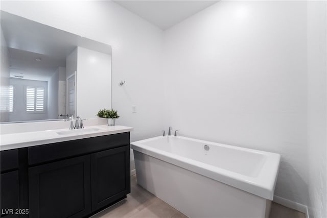 bathroom with a tub to relax in and vanity