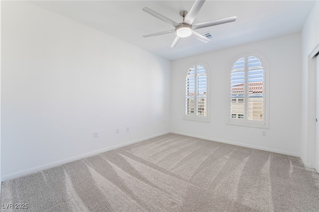 empty room featuring carpet floors and ceiling fan