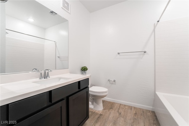 full bathroom featuring toilet,  shower combination, wood-type flooring, and vanity