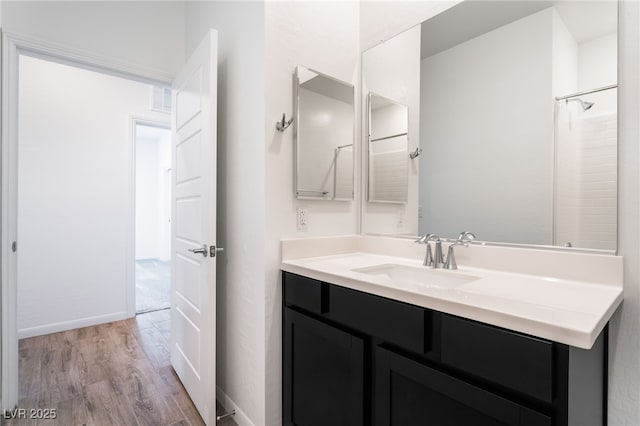 bathroom with hardwood / wood-style floors and vanity