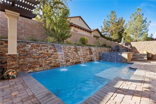 view of swimming pool with a patio area and pool water feature