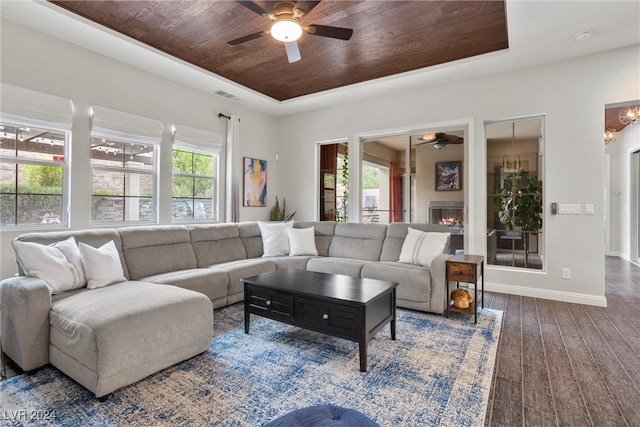 living room featuring ceiling fan, wooden ceiling, and dark hardwood / wood-style flooring